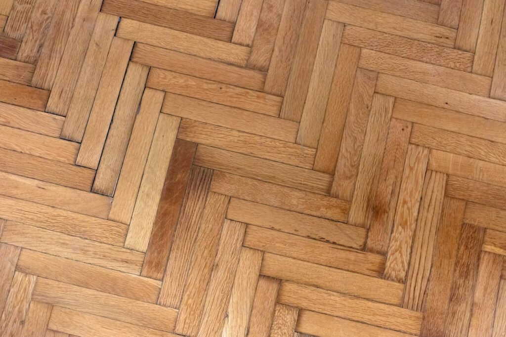 Herringbone pattern parquet wood floor texture. Wooden oak flooring background, overhead