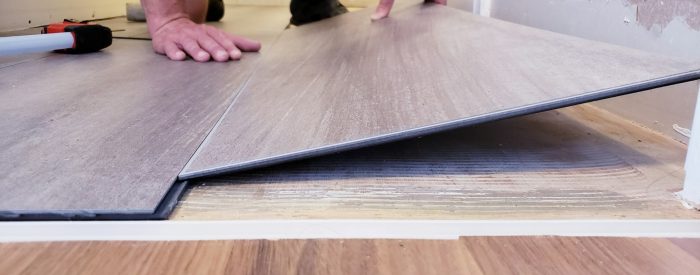 Floor level view of laminate flooring installation, home renovation, construction materials, tiles